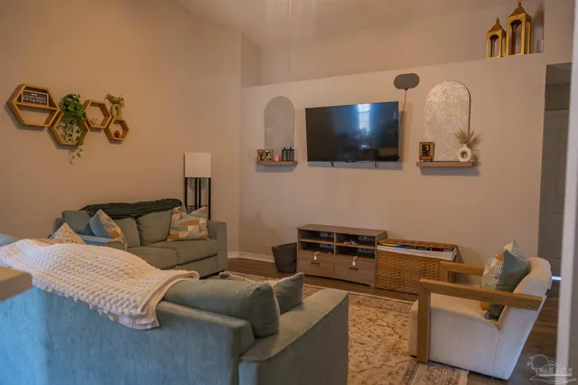 a living room with furniture and a flat screen tv