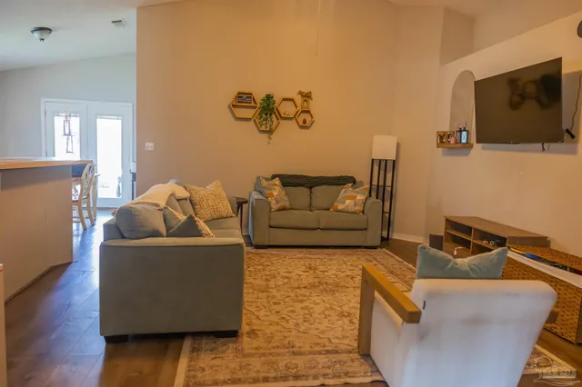 a living room with furniture and a flat screen tv