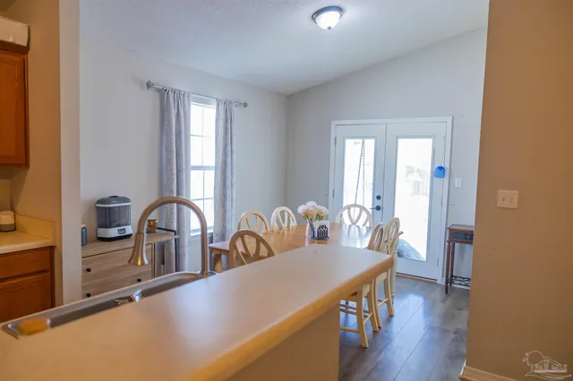 a dining room with furniture and wooden floor