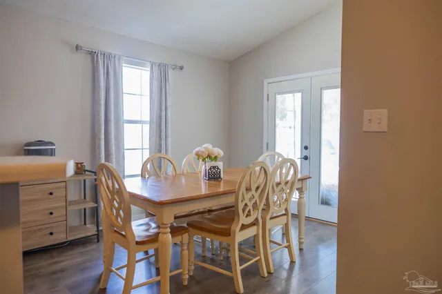 a dining room with furniture and window