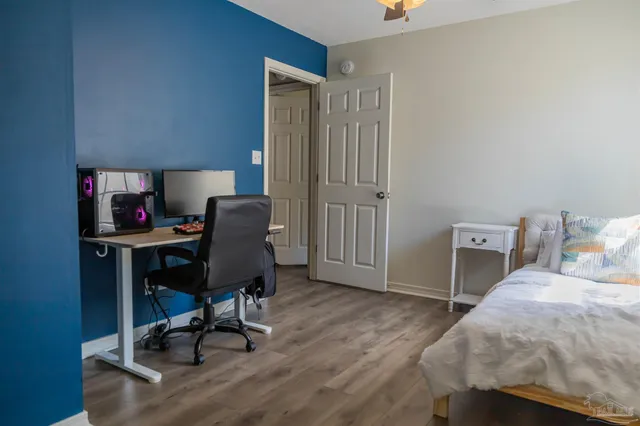a view of a workspace with furniture and a bedroom