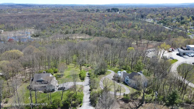 an aerial view of a houses with a yard