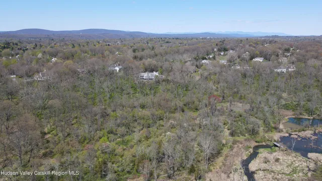 an aerial view of town with residential houses and mountain view