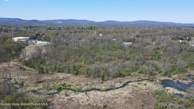 a view of a lush green hillside and houses