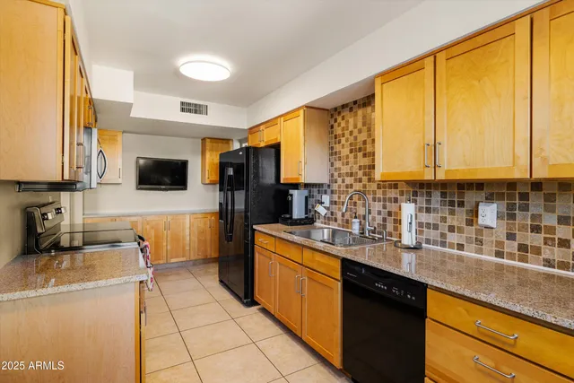 a kitchen with a stove a sink and a microwave