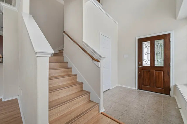 a view of entryway and hall with wooden floor