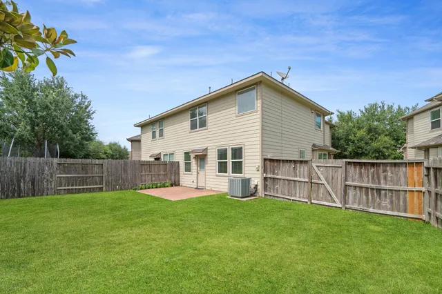 a view of a house with a yard and sitting area