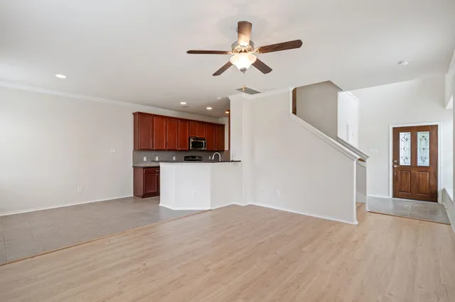 a view of a kitchen with a microwave and a ceiling fan