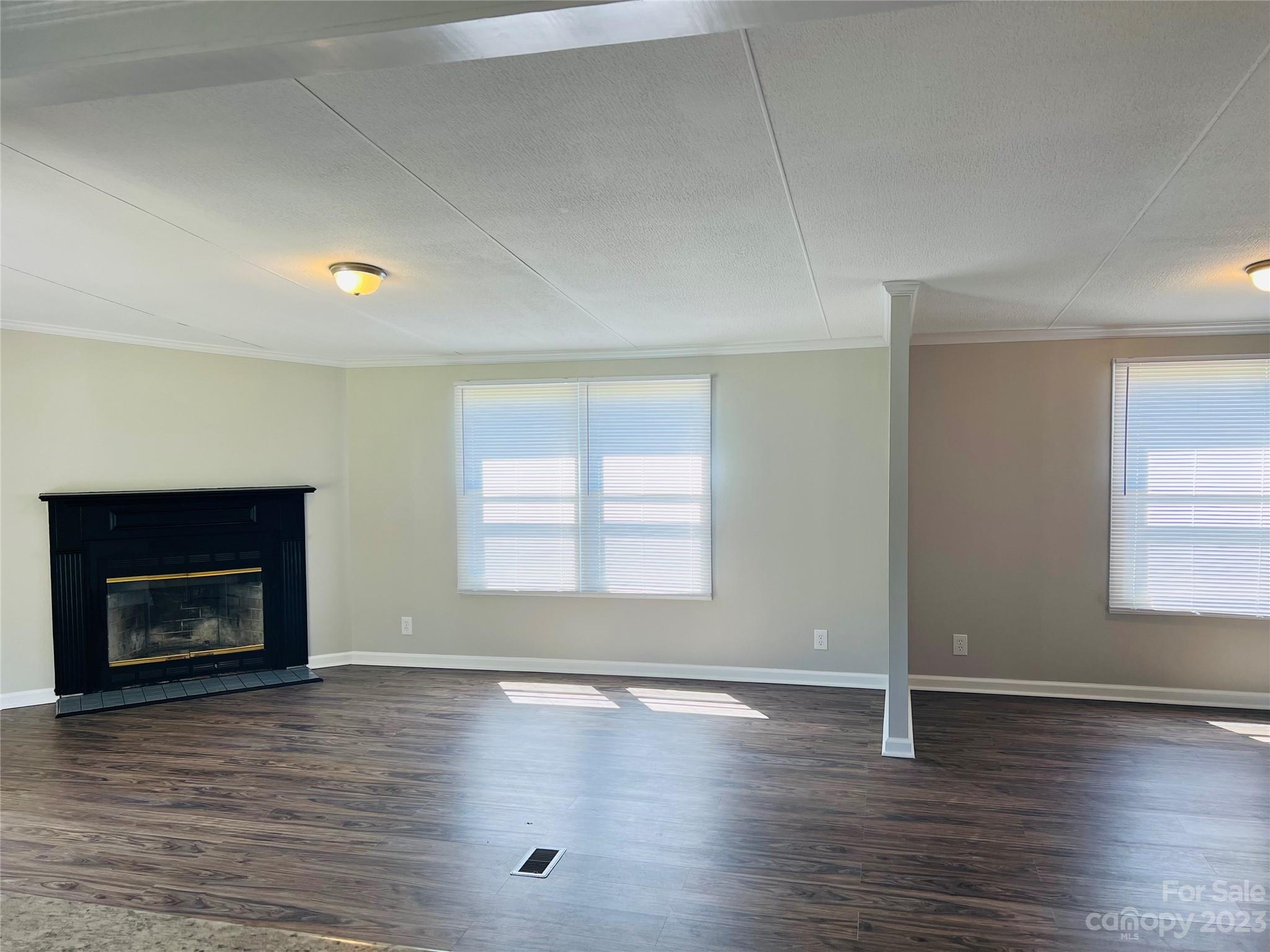 5310 Fallston Road Lawndale, NC 28090 - Photo 11 of 20 an empty room with wooden floor fireplace and windows