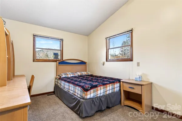 a bedroom with a bed and a lamp on table