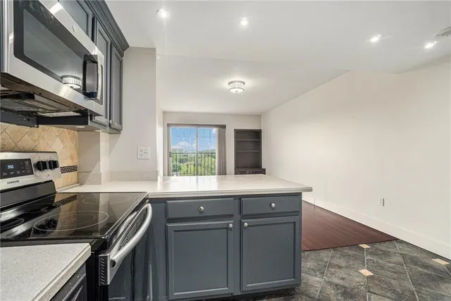 a bedroom with a bed a chandelier and a window