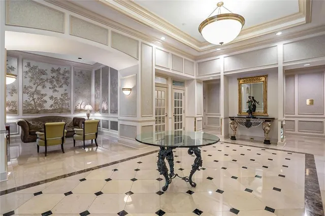 a room with furniture a large window and a chandelier