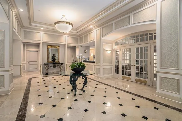 a living room with furniture a rug and white walls