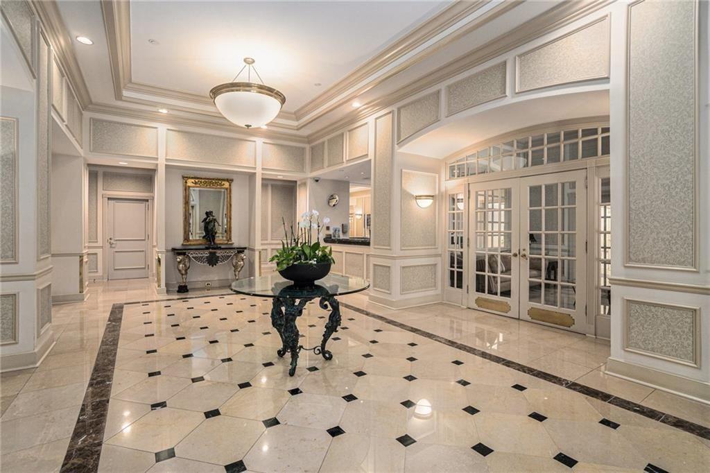 199 14th Street Northeast, Unit 704 Atlanta, GA 30309 - Photo 5 of 34 a living room with furniture a rug and white walls