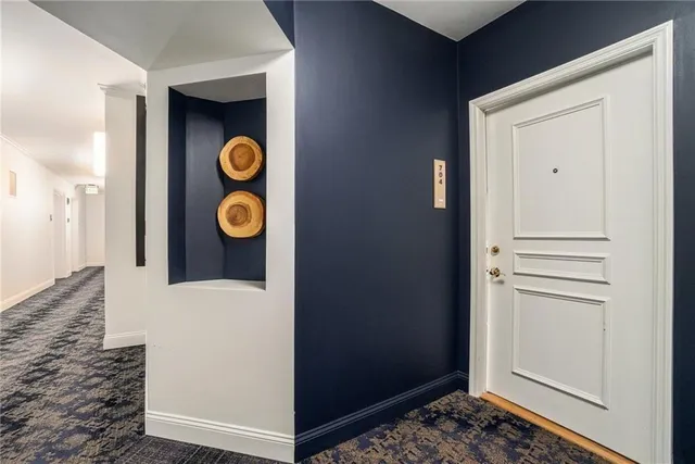 a living room with furniture and kitchen view