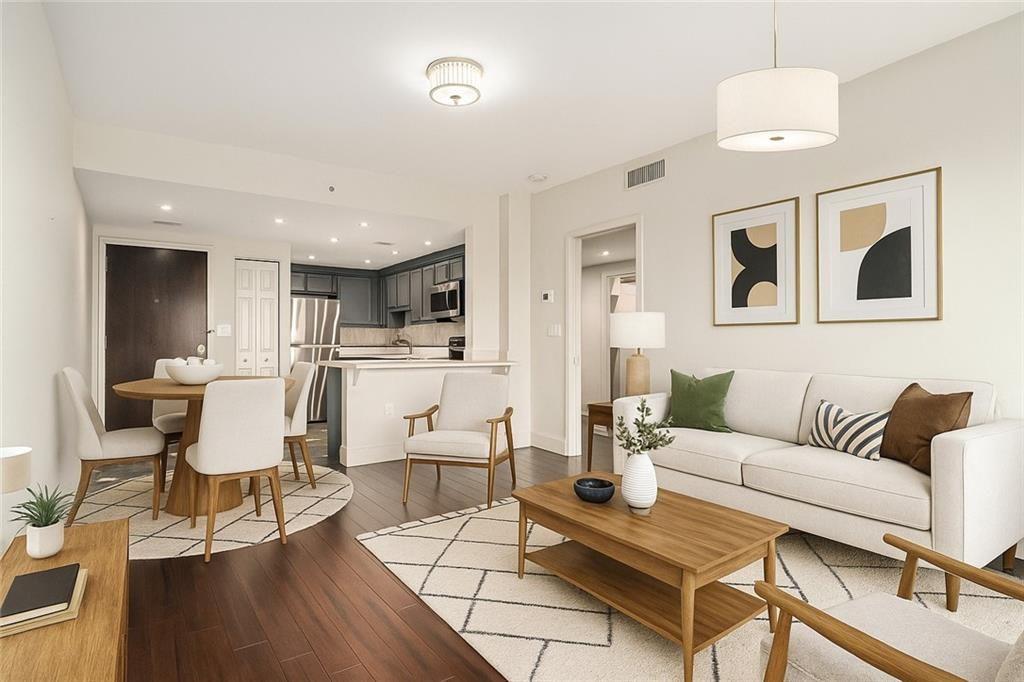 199 14th Street Northeast, Unit 704 Atlanta, GA 30309 - Photo 10 of 34 a living room with furniture and kitchen view