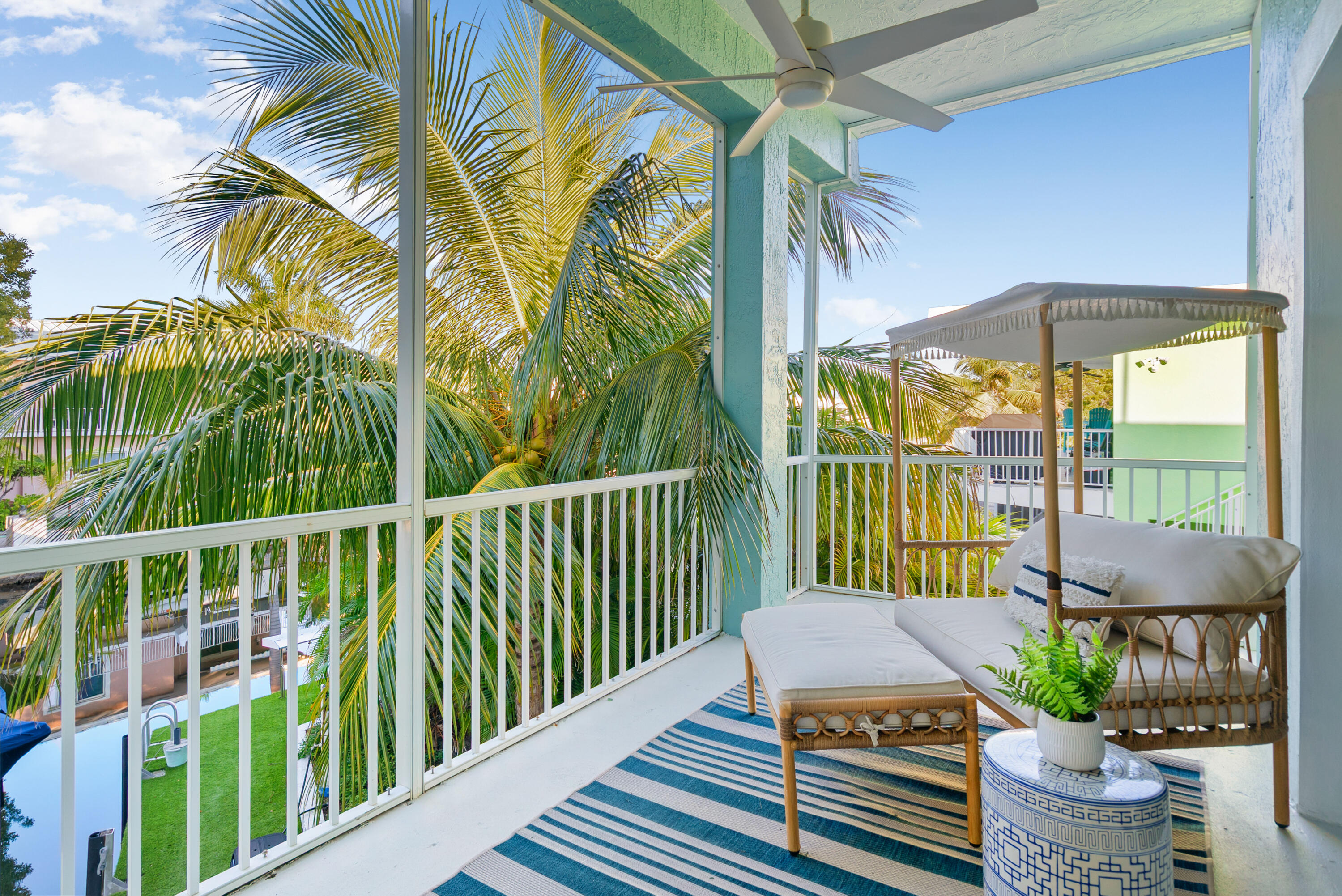 127 Peace Avenue Key Largo, FL 33070 - Photo 18 of 56 a roof deck with table and chairs under an umbrella