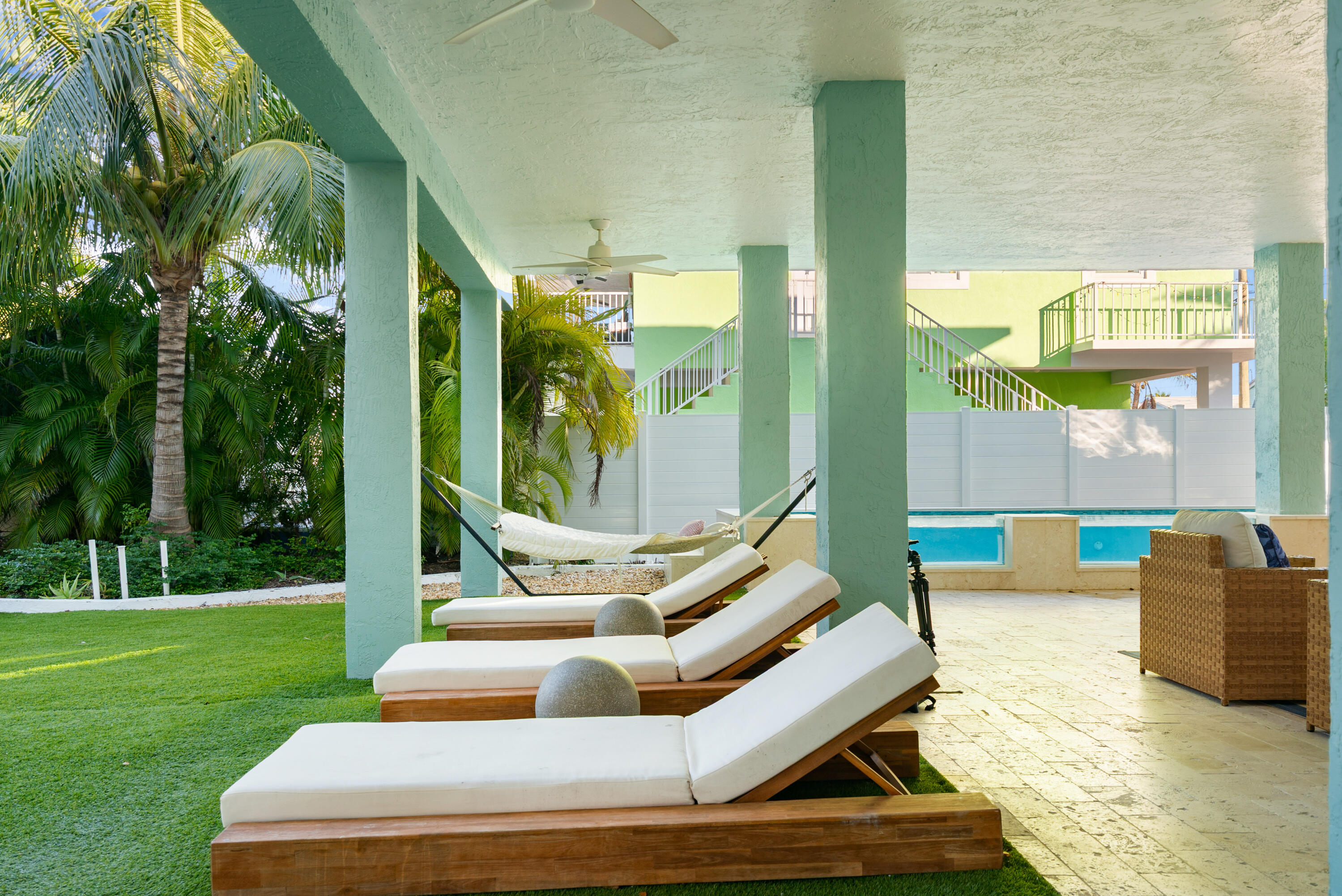 127 Peace Avenue Key Largo, FL 33070 - Photo 30 of 56 a view of a patio with couches chairs and a yard