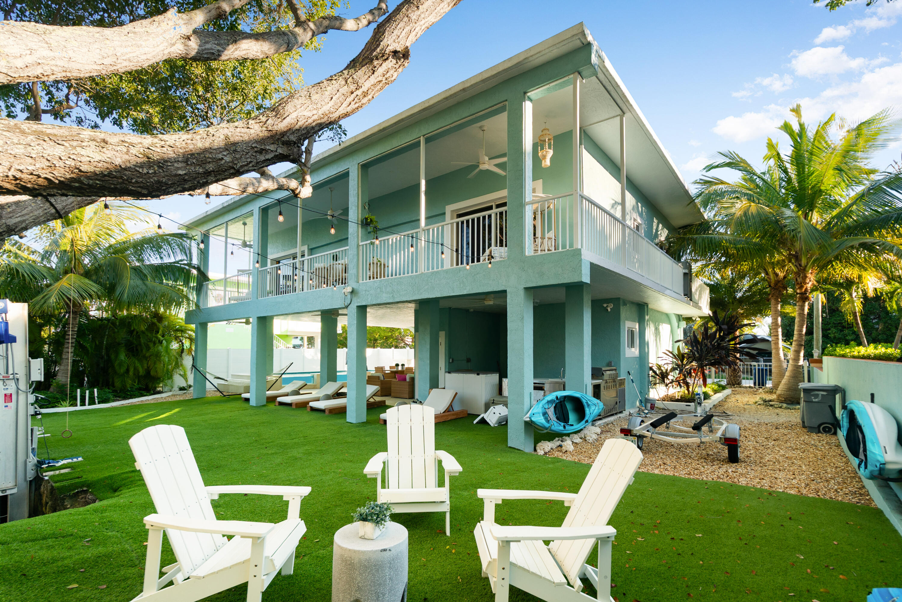 127 Peace Avenue Key Largo, FL 33070 - Photo 4 of 56 a front view of a house with a yard table and chairs