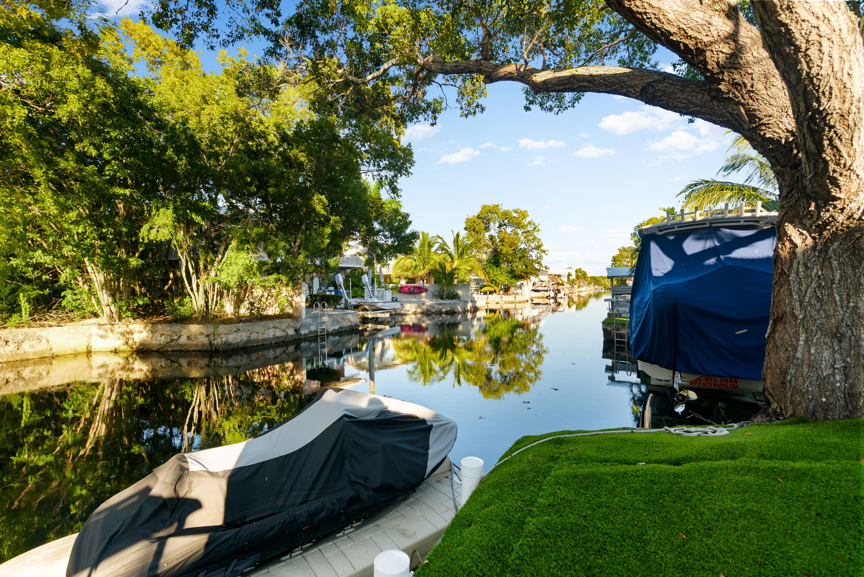 127 Peace Avenue Key Largo, FL 33070 - Photo 6 of 56 a view of a lake with a bench and trees
