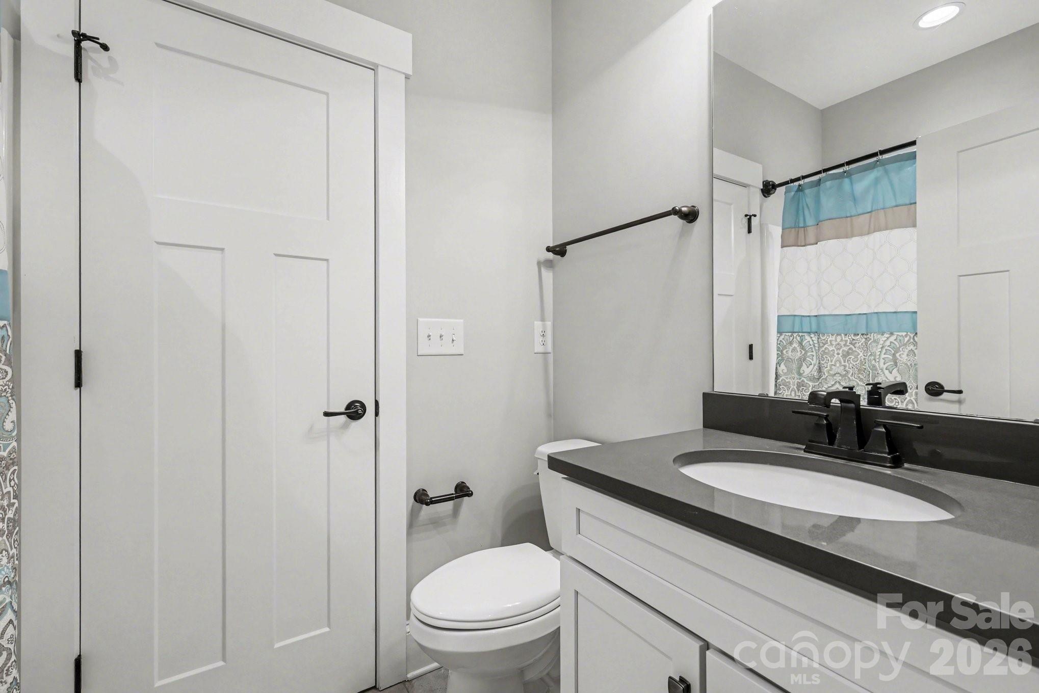 4193 Persimmon Road Lancaster, SC 29720 - Photo 24 of 42 a bathroom with a granite countertop sink toilet and shower