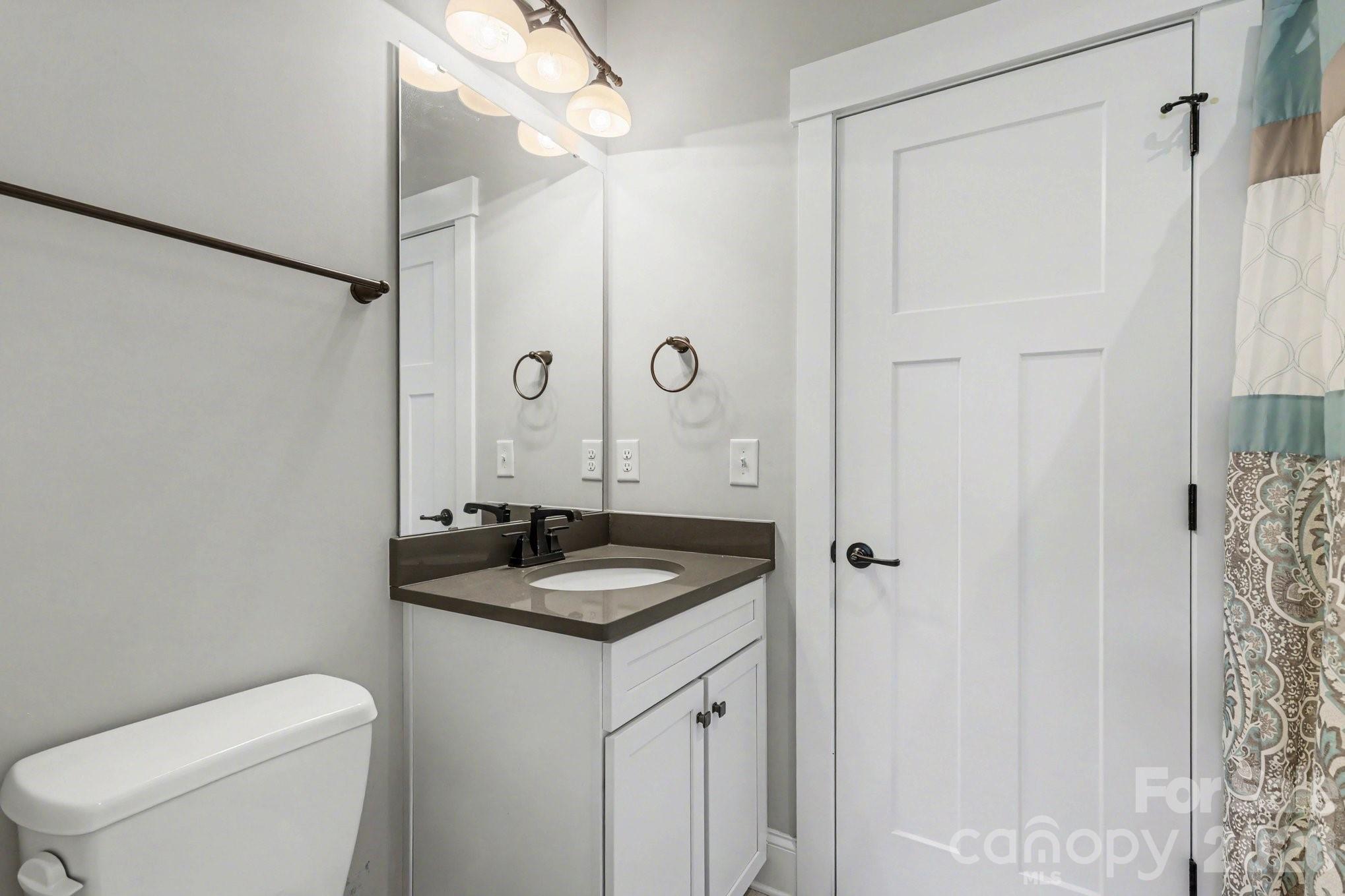 4193 Persimmon Road Lancaster, SC 29720 - Photo 26 of 42 a bathroom with a granite countertop sink toilet and shower