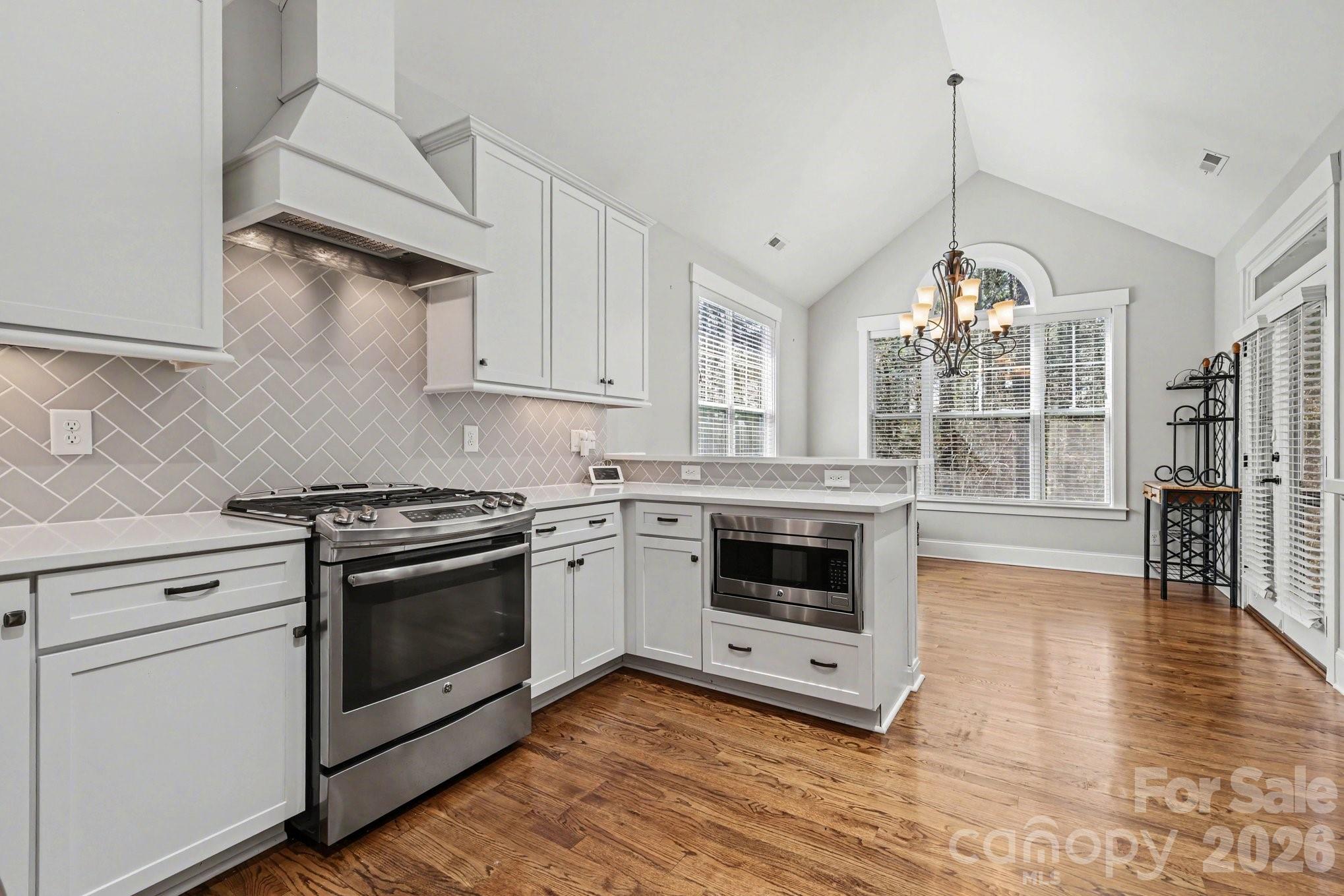 4193 Persimmon Road Lancaster, SC 29720 - Photo 8 of 42 a kitchen with stainless steel appliances granite countertop a stove and white cabinets