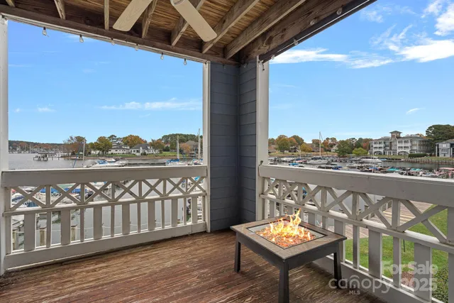 a view of a balcony with wooden floor and outdoor seating