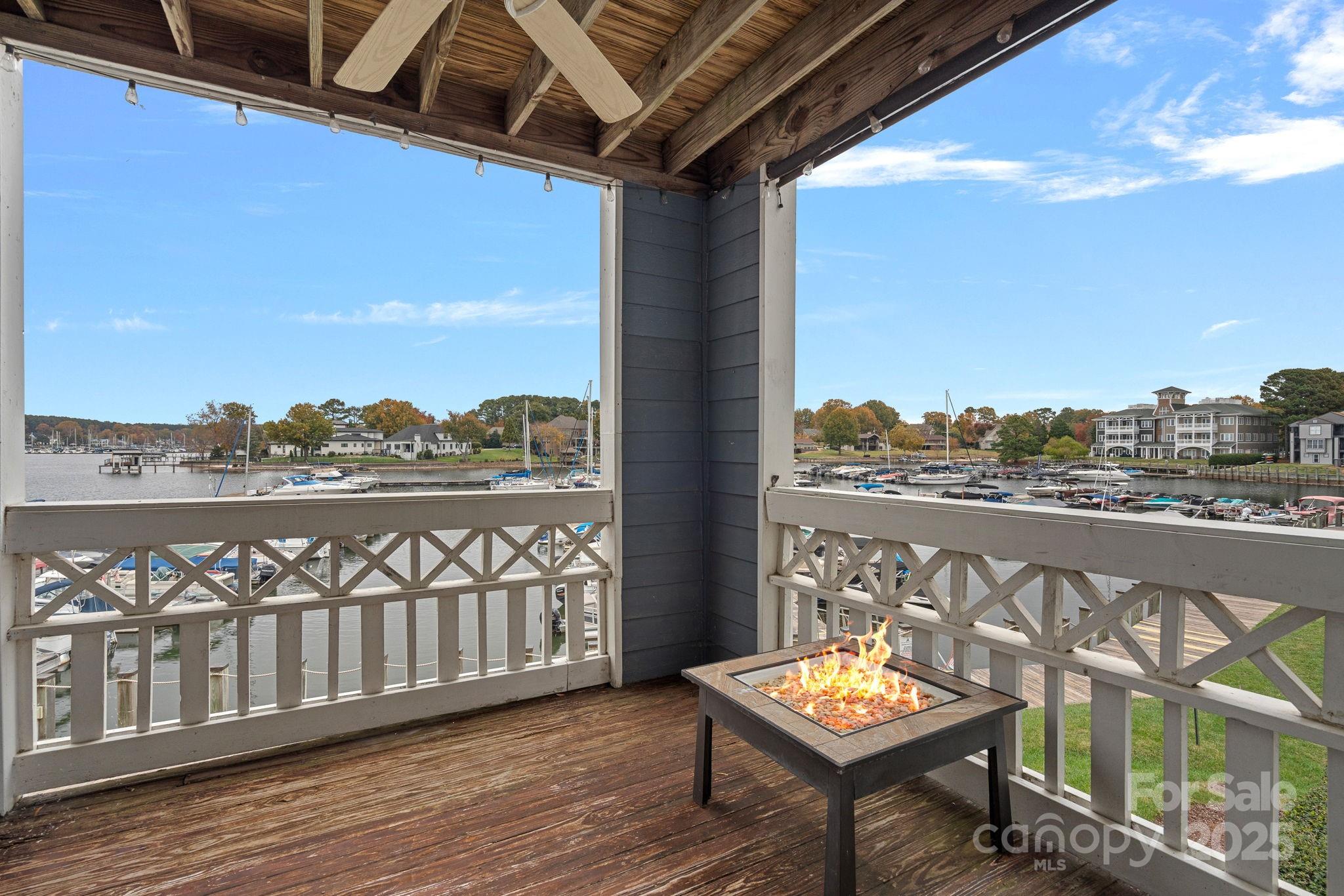 a view of a balcony with wooden floor and outdoor seating