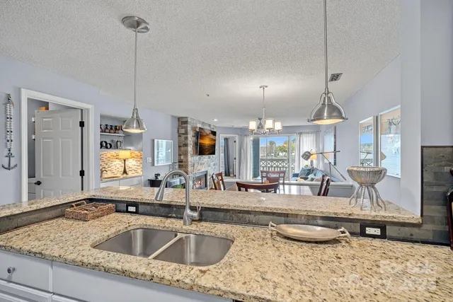 a kitchen with sink refrigerator and window