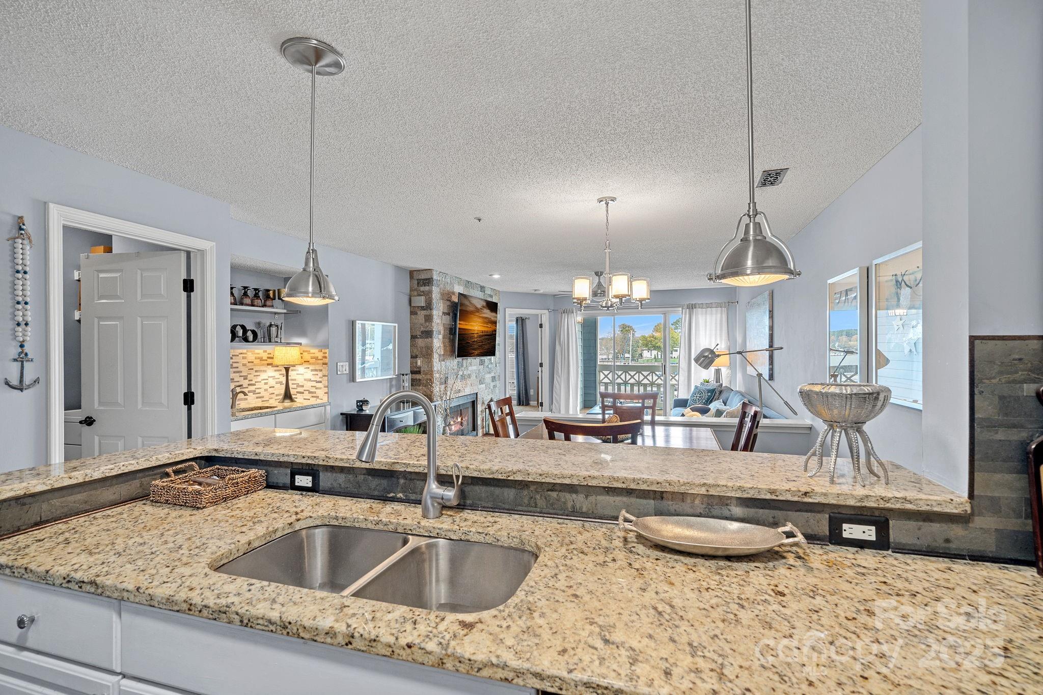 18673 Vineyard Point Lane Cornelius, NC 28031 - Photo 13 of 29 a kitchen with sink refrigerator and window
