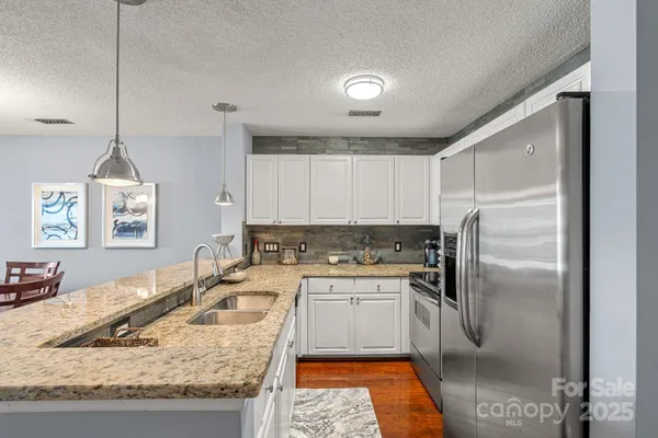 a kitchen with a sink a stove and a refrigerator