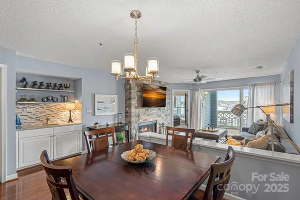 a view of a dining room with furniture a chandelier and wooden floor