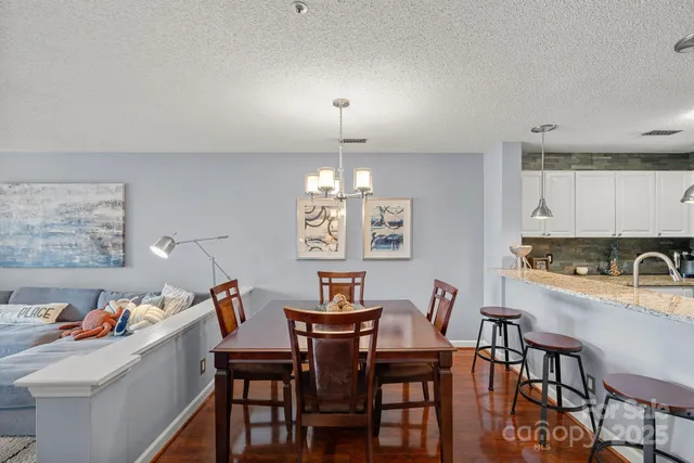 a view of a dining room with furniture and chandelier
