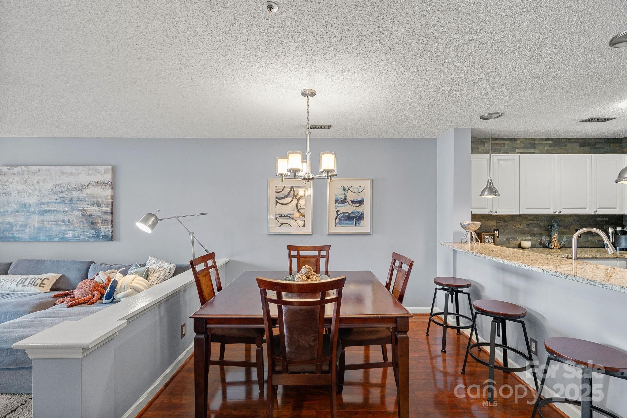 18673 Vineyard Point Lane Cornelius, NC 28031 - Photo 16 of 29 a view of a dining room with furniture and chandelier
