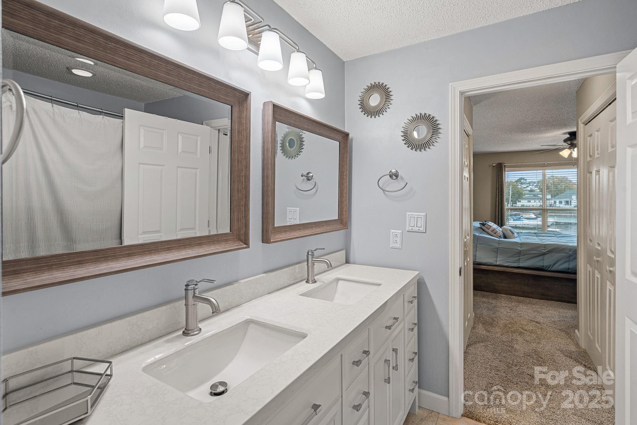 18673 Vineyard Point Lane Cornelius, NC 28031 - Photo 19 of 29 a en suite bathroom with a double vanity sink and a mirror