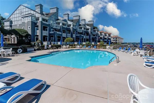 a view of a swimming pool with outdoor seating