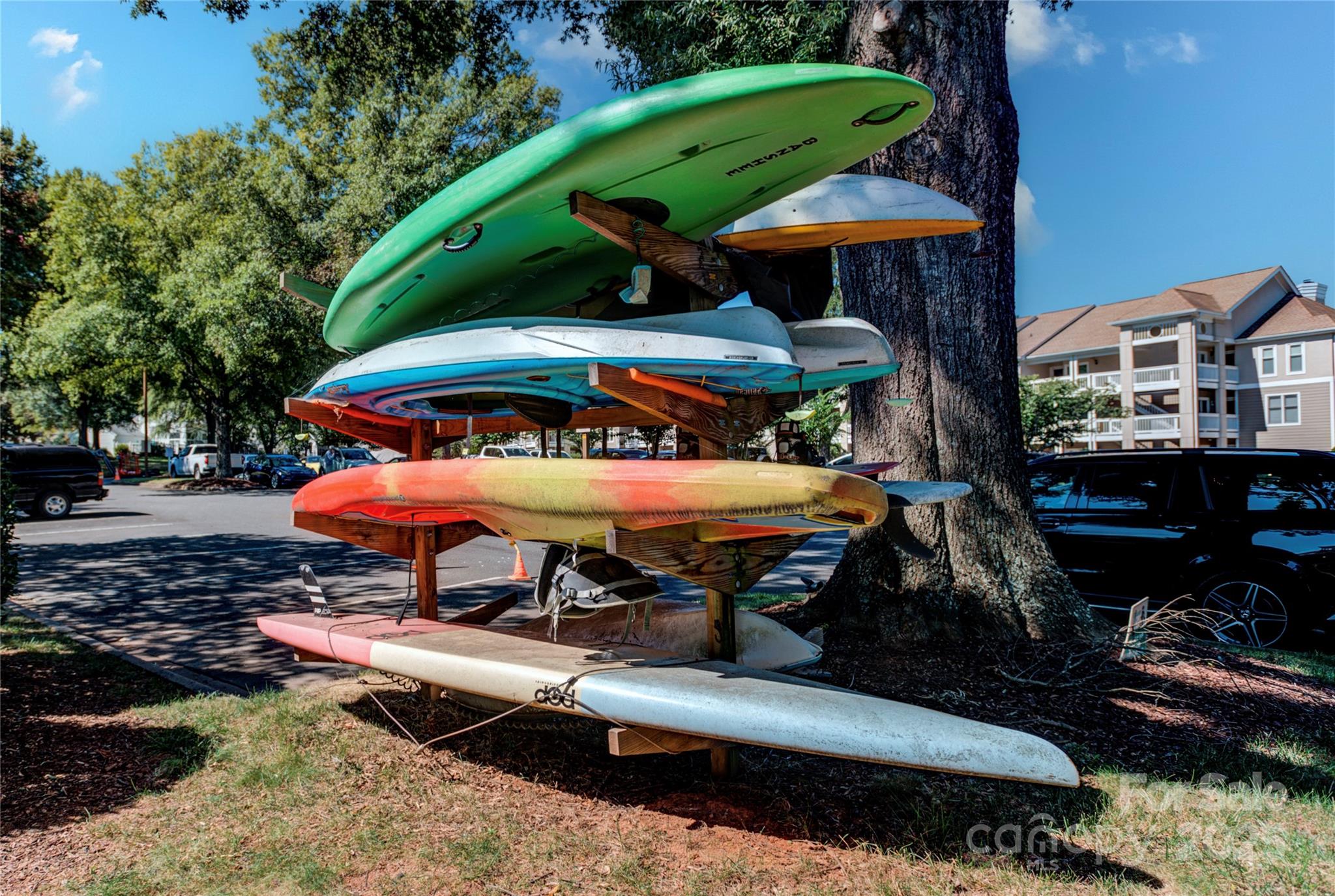 18673 Vineyard Point Lane Cornelius, NC 28031 - Photo 25 of 29 a view of a chairs and table under an umbrella in backyard