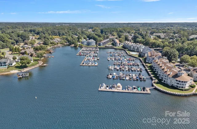 an aerial view of residential house with outdoor space and trees all around