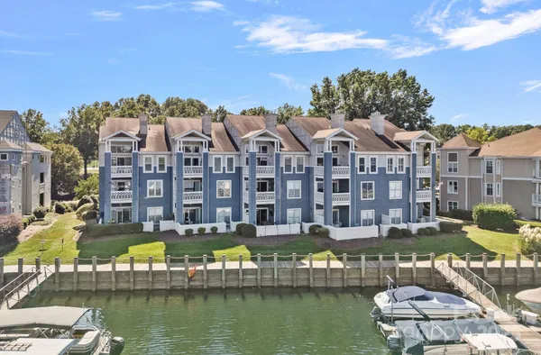 a front view of a building with lake view and boat