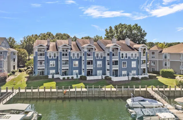 a front view of a building with lake view and boat