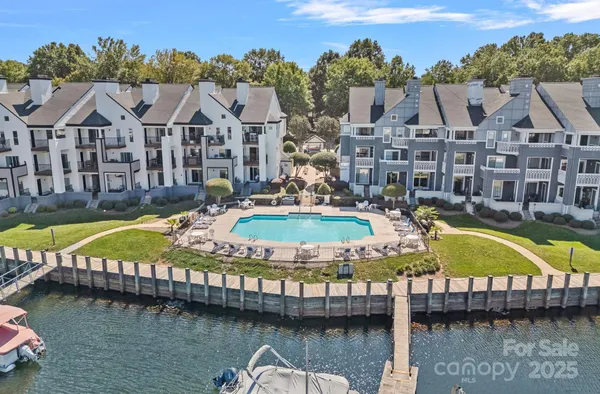 a view of a swimming pool with a patio next to a yard