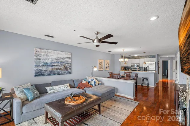 a living room with furniture and kitchen view