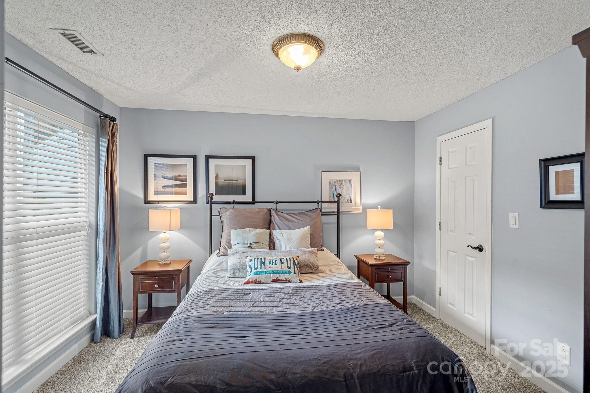 18673 Vineyard Point Lane Cornelius, NC 28031 - Photo 8 of 29 a bedroom with a bed and wooden floor