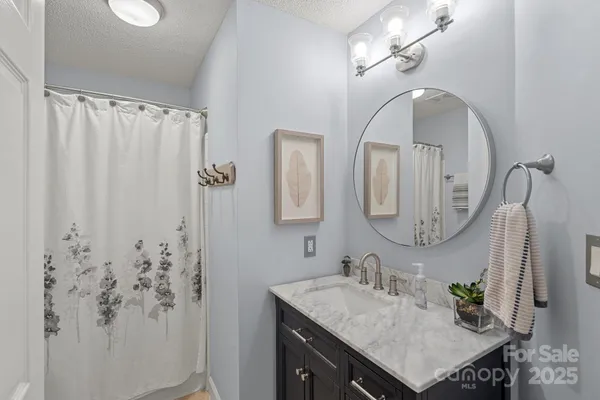 a bathroom with a sink vanity and a mirror