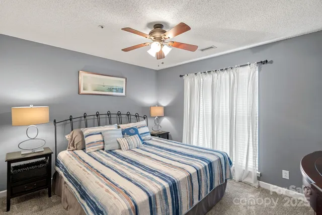 a bedroom with bed and a chandelier