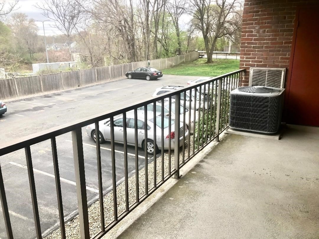 146 Marble Street, Unit 204 Stoneham, MA 02180 - Photo 12 of 21 a view of a porch with yard and wooden fence