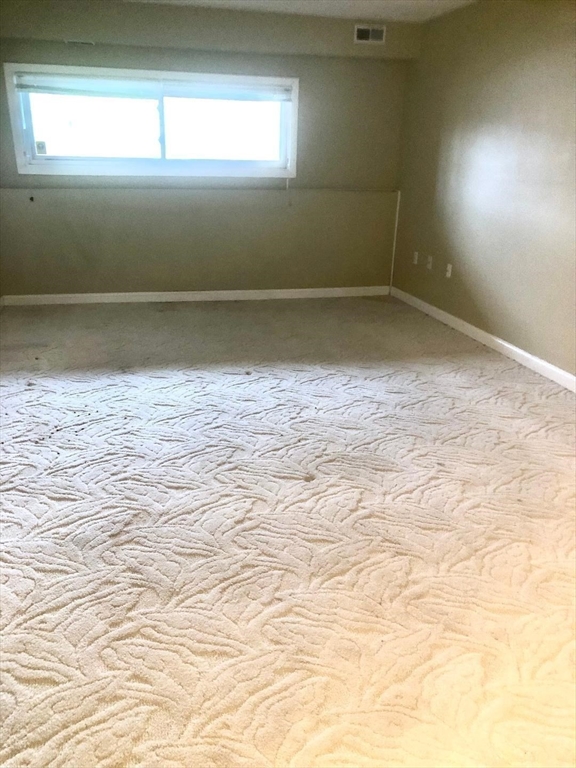 146 Marble Street, Unit 204 Stoneham, MA 02180 - Photo 18 of 21 en empty room with window