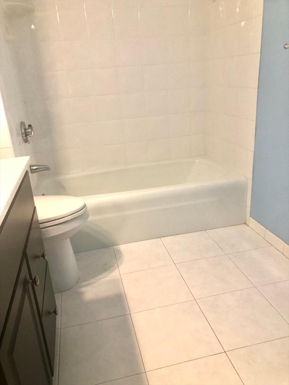 146 Marble Street, Unit 204 Stoneham, MA 02180 - Photo 9 of 21 a bathroom with a toilet and a bathtub