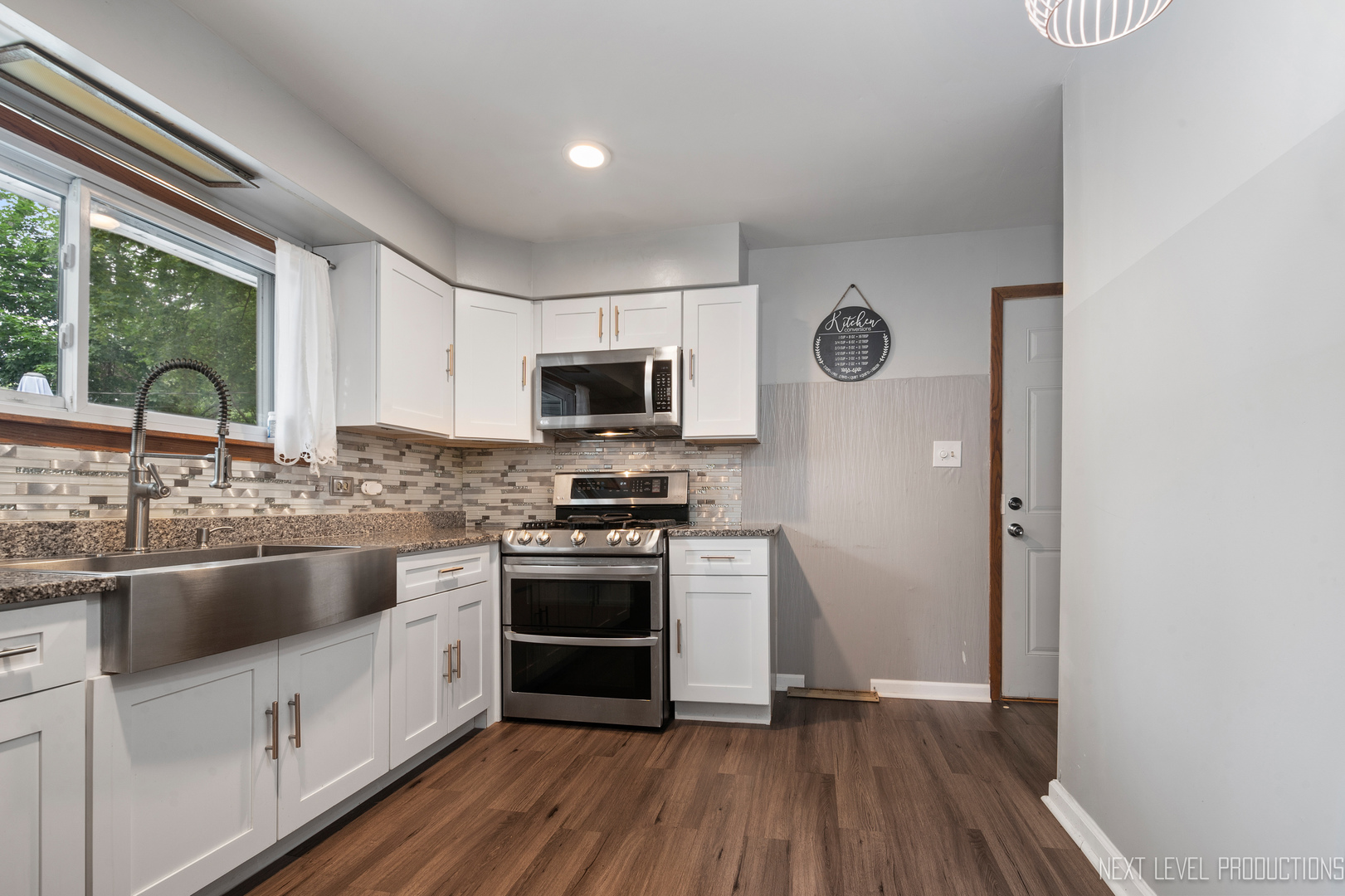 22816 Ridgeway Avenue Richton Park, IL 60471 - Photo 10 of 25 a kitchen with stainless steel appliances granite countertop a stove a sink and a microwave